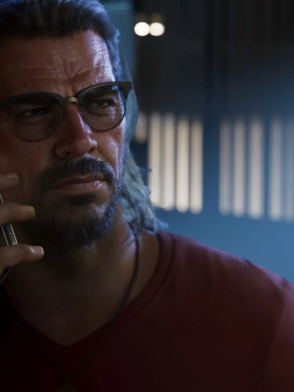 Raul Bautista on the phone in a darkened room